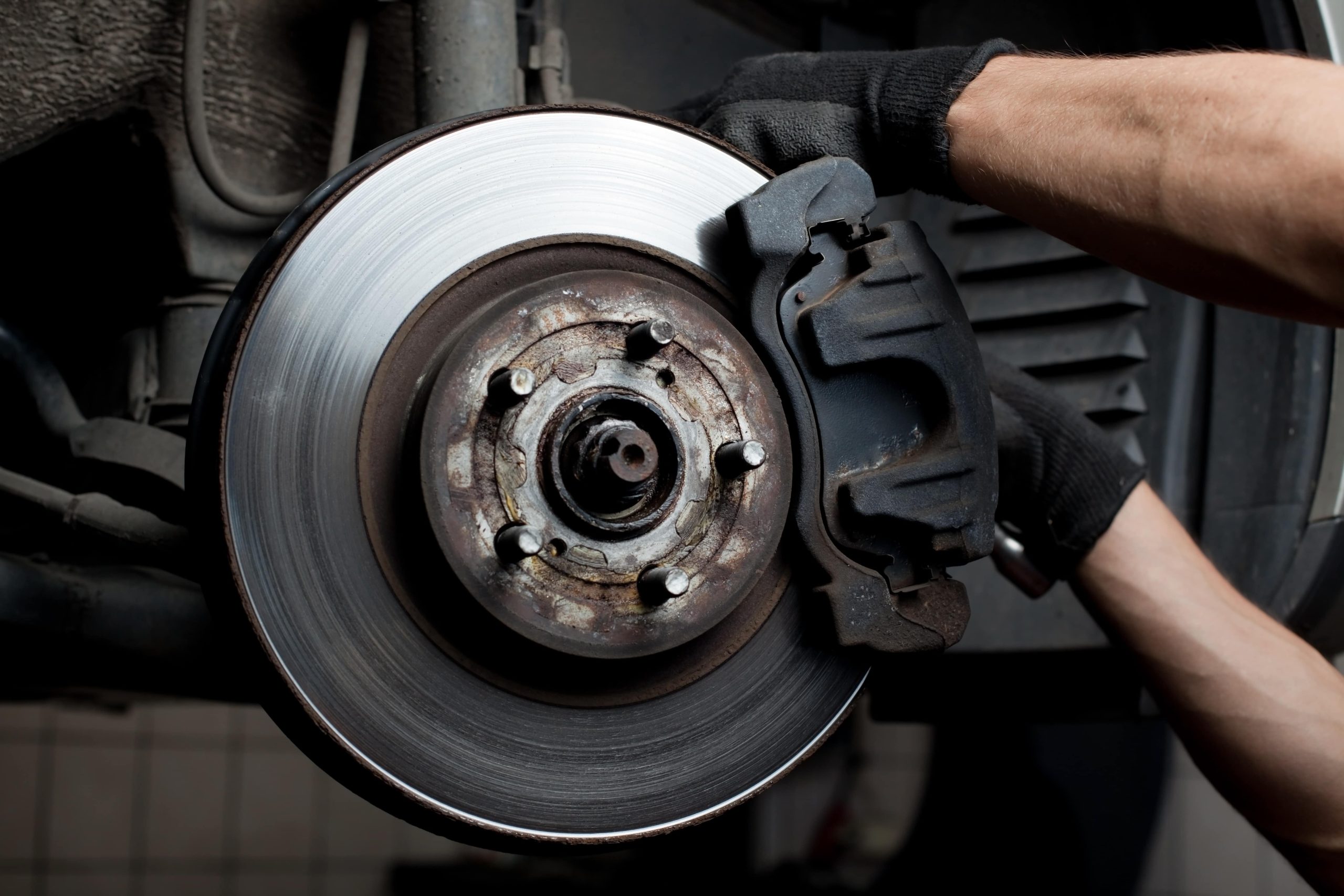 Brakes on a car that are dirty and need replacement