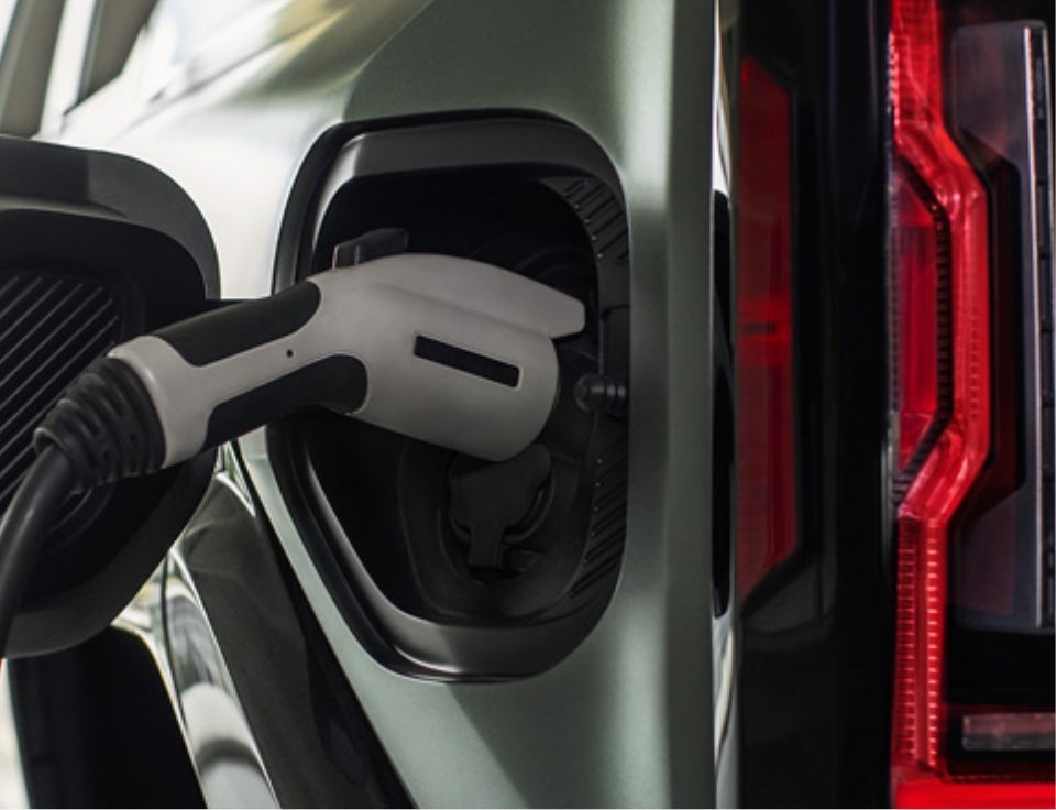 Close up of charging port with charger plugged in on a GMC Hummer EV SUV - Robert Brogden's Hays GMC in Hays KS